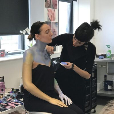 body paint being applied to the chest