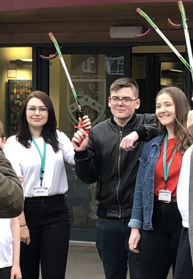 students with mechanical grabbers