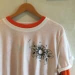 Floral graphic printed on white t-shirt.
