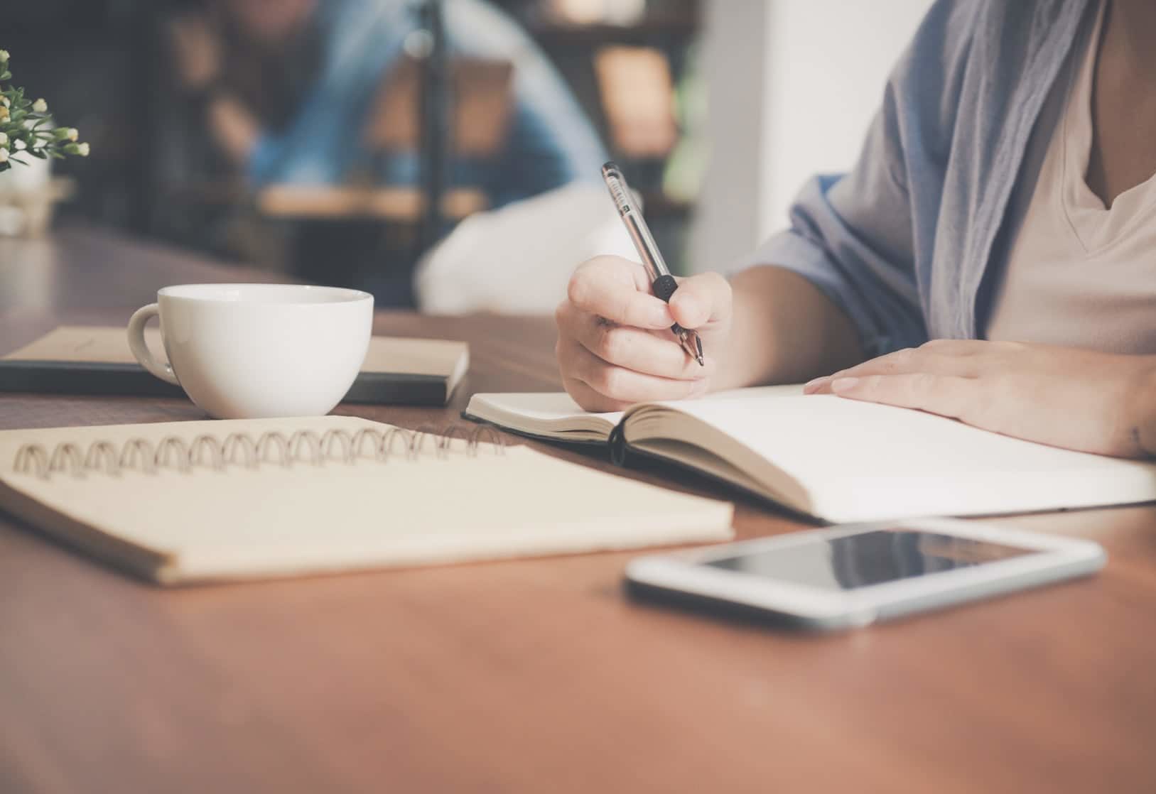 Student writing on a notepad
