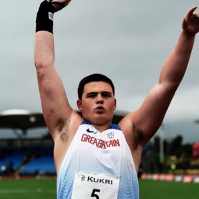 Sport student Lewis Byng holding a shot put