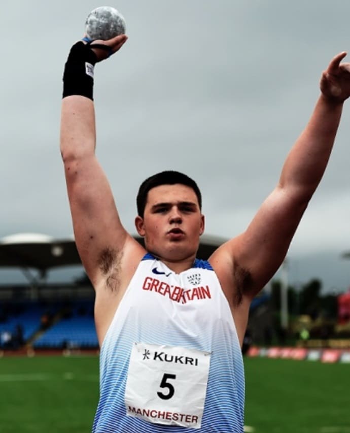 Sport student Lewis Byng holding a shot put