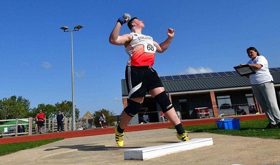 Student Lewis throwing shot put