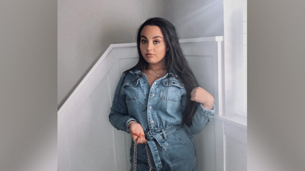 Student Tilly Kirby standing with bag in hand