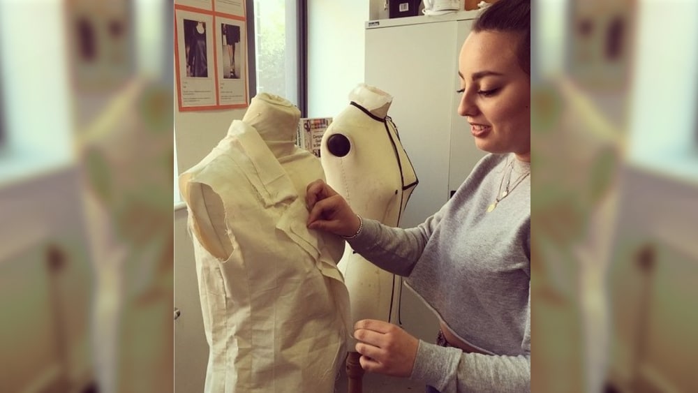 Student pinning dressmakers mannequin