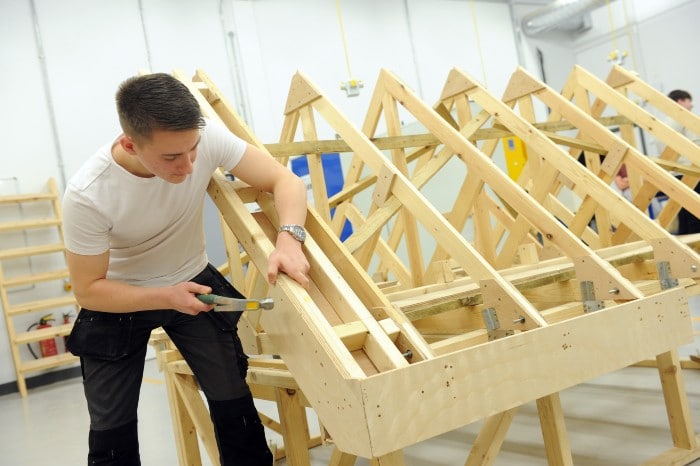 Student working on a roof