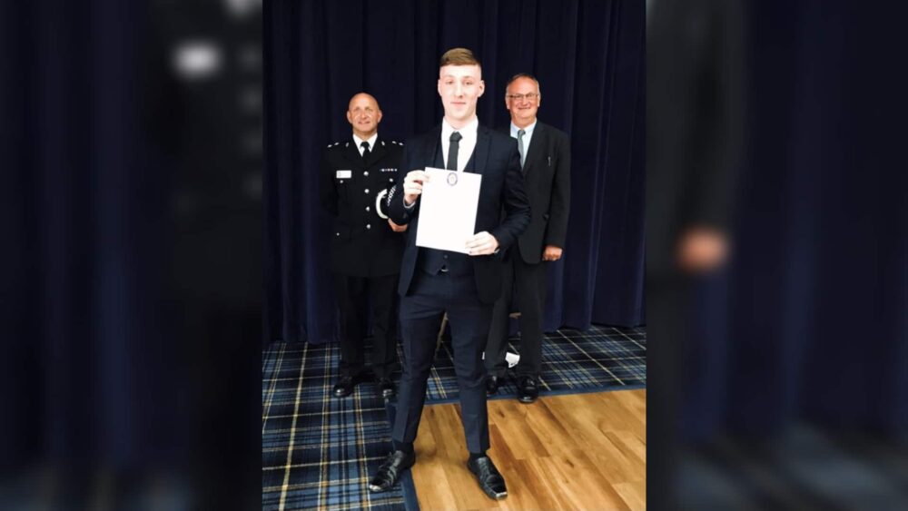 Student showing certificate