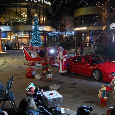 Cameras in front of santa and ferrari