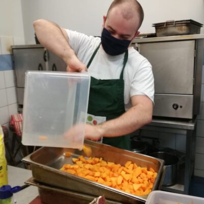 Student putting squash into roasting tray