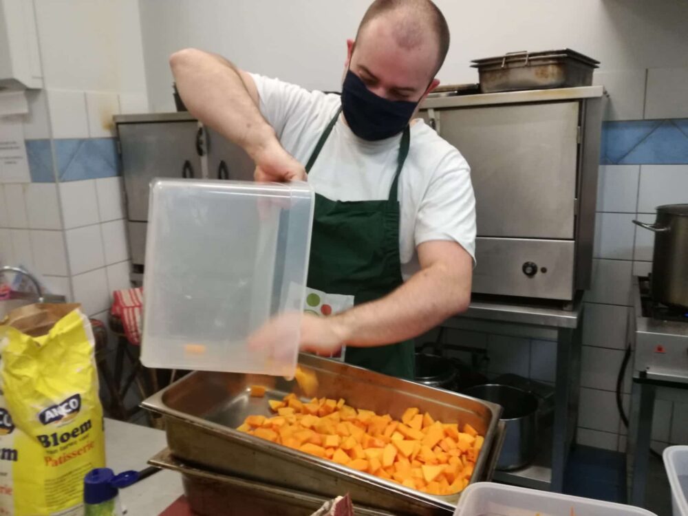 Student putting squash into roasting tray