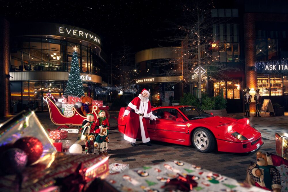 Santa standing in front of a ferrari