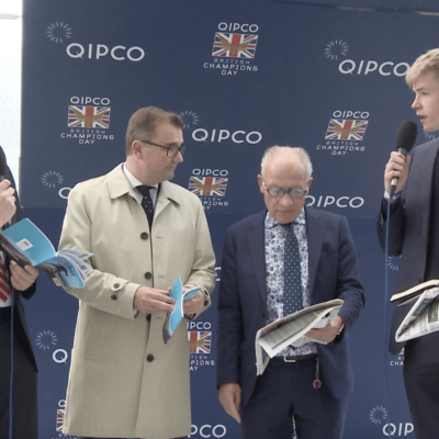 4 men standing one with mic