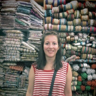 Louisa standing in front of material