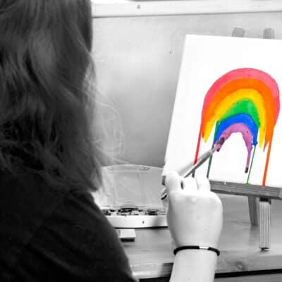 student painting rainbow