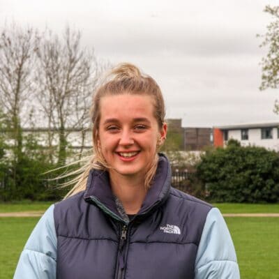 Student looking at camera smiling at Stratford-Upon-Avon College