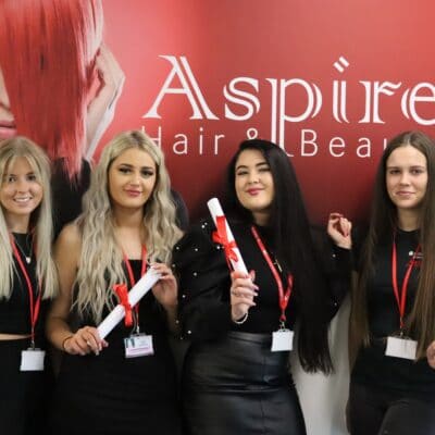 4 students standing in front of Aspire sign