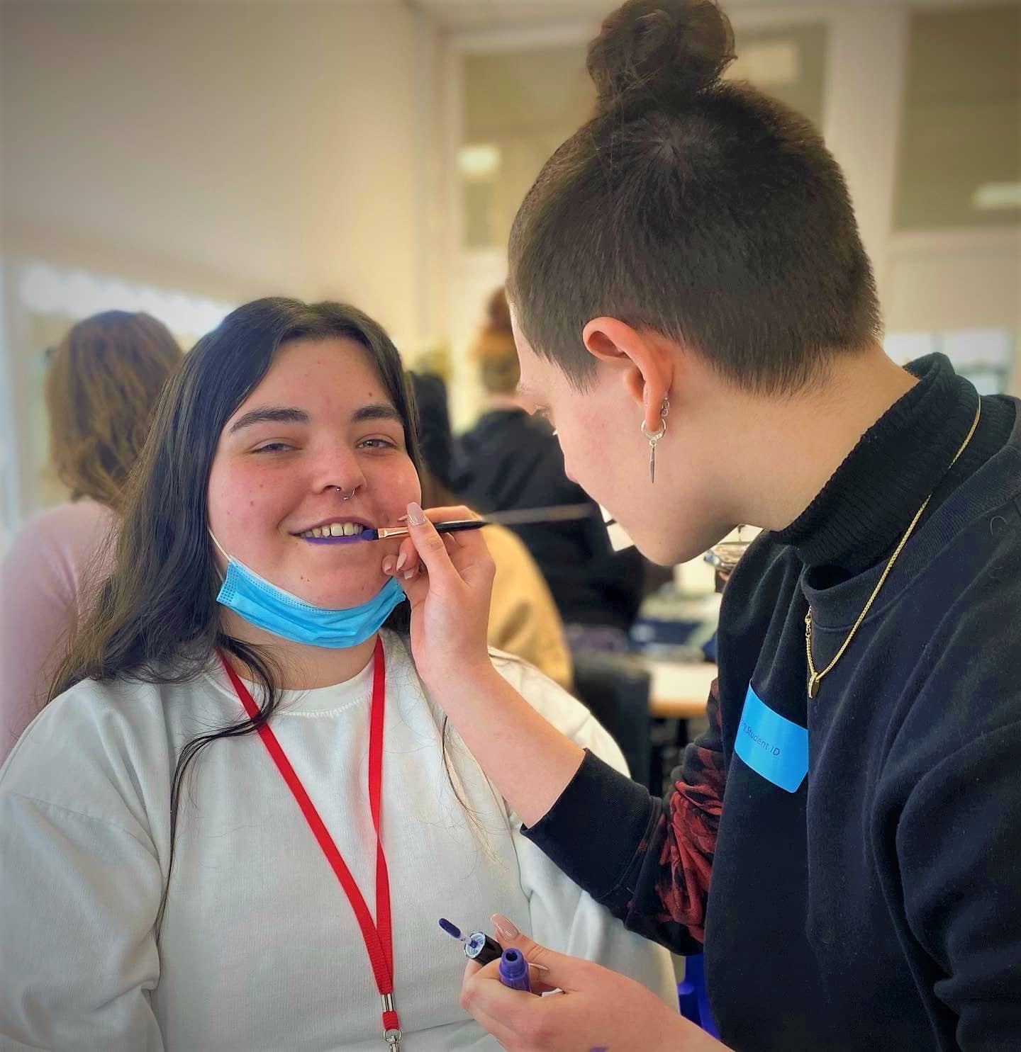 Emily doing make up on student