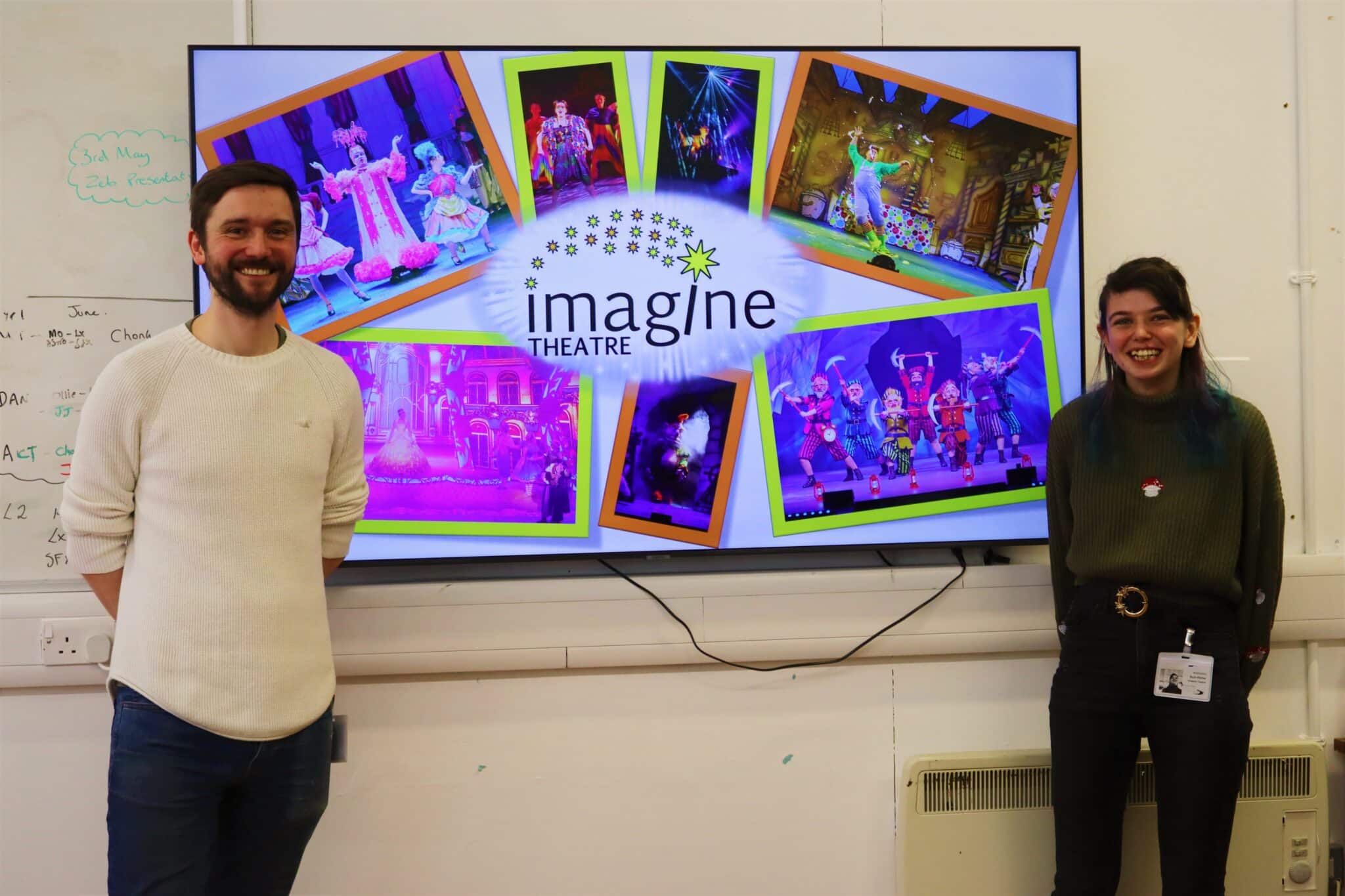 ruth and callum in front of a screen showcasing