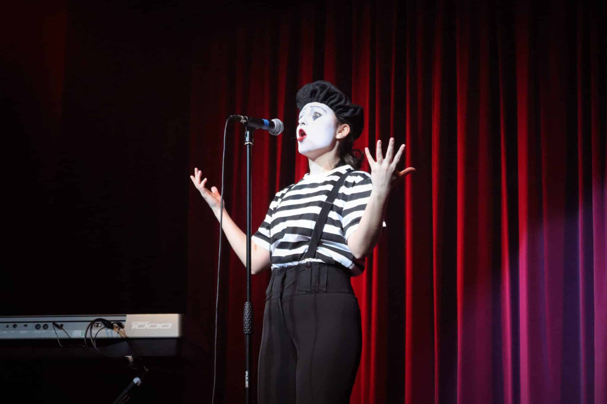 Student dressed as mime on mic