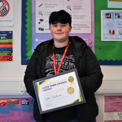 Tyler Tomlinson with award