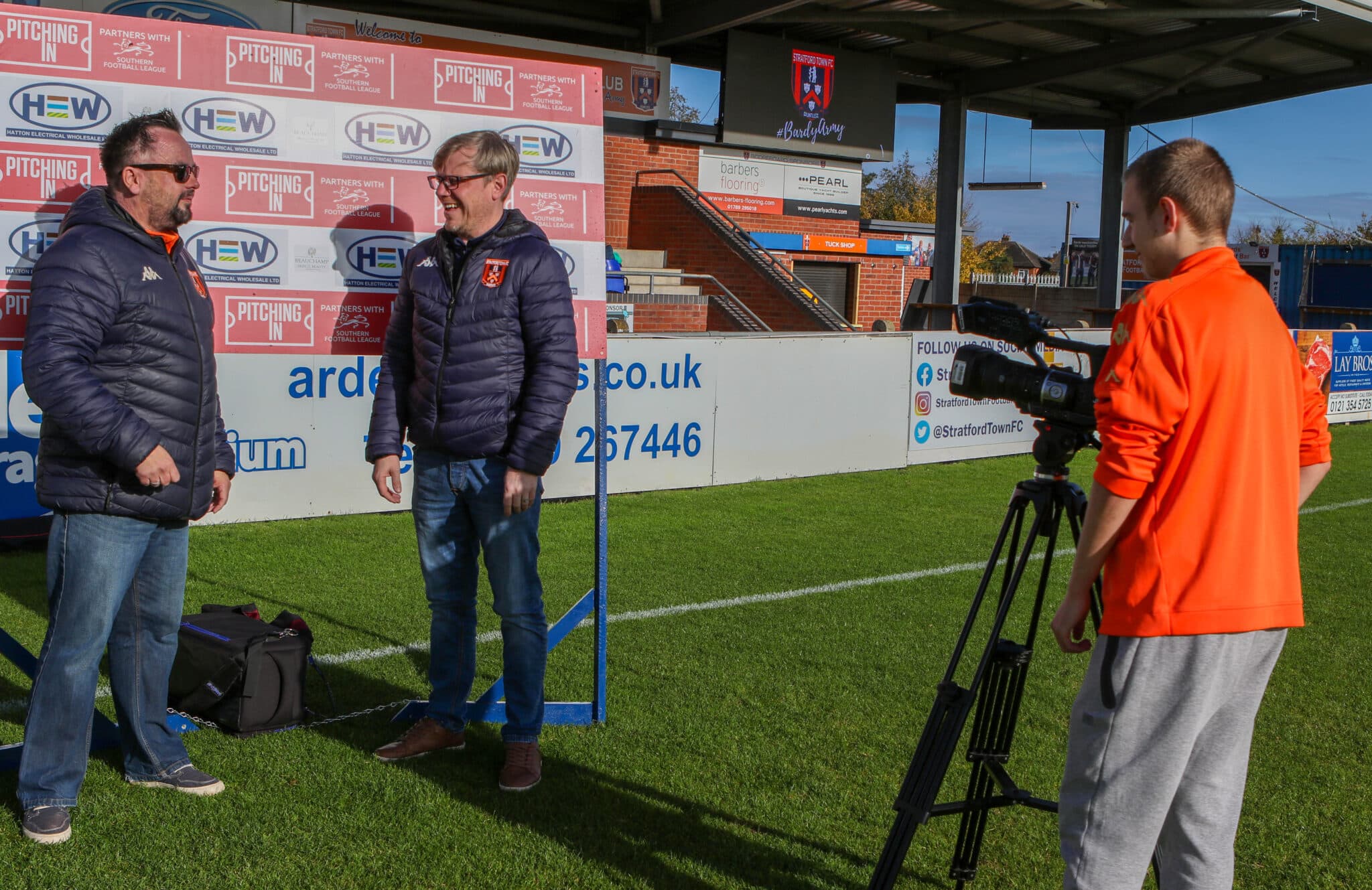 student alex filming interview at football club