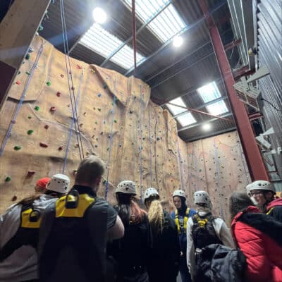 education student on climbing wall