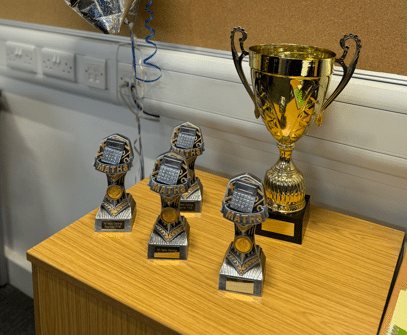 3 trophies on a table