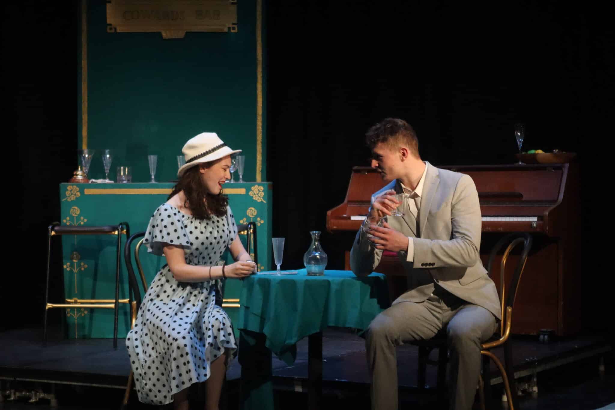 Two actors sat at a table