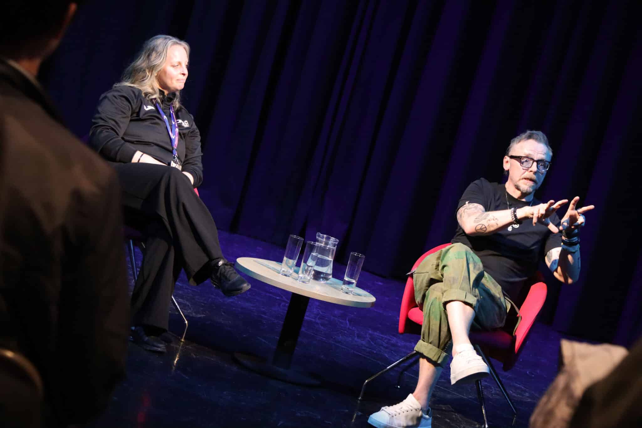 Simon Pegg gesticulating as he talks to audience