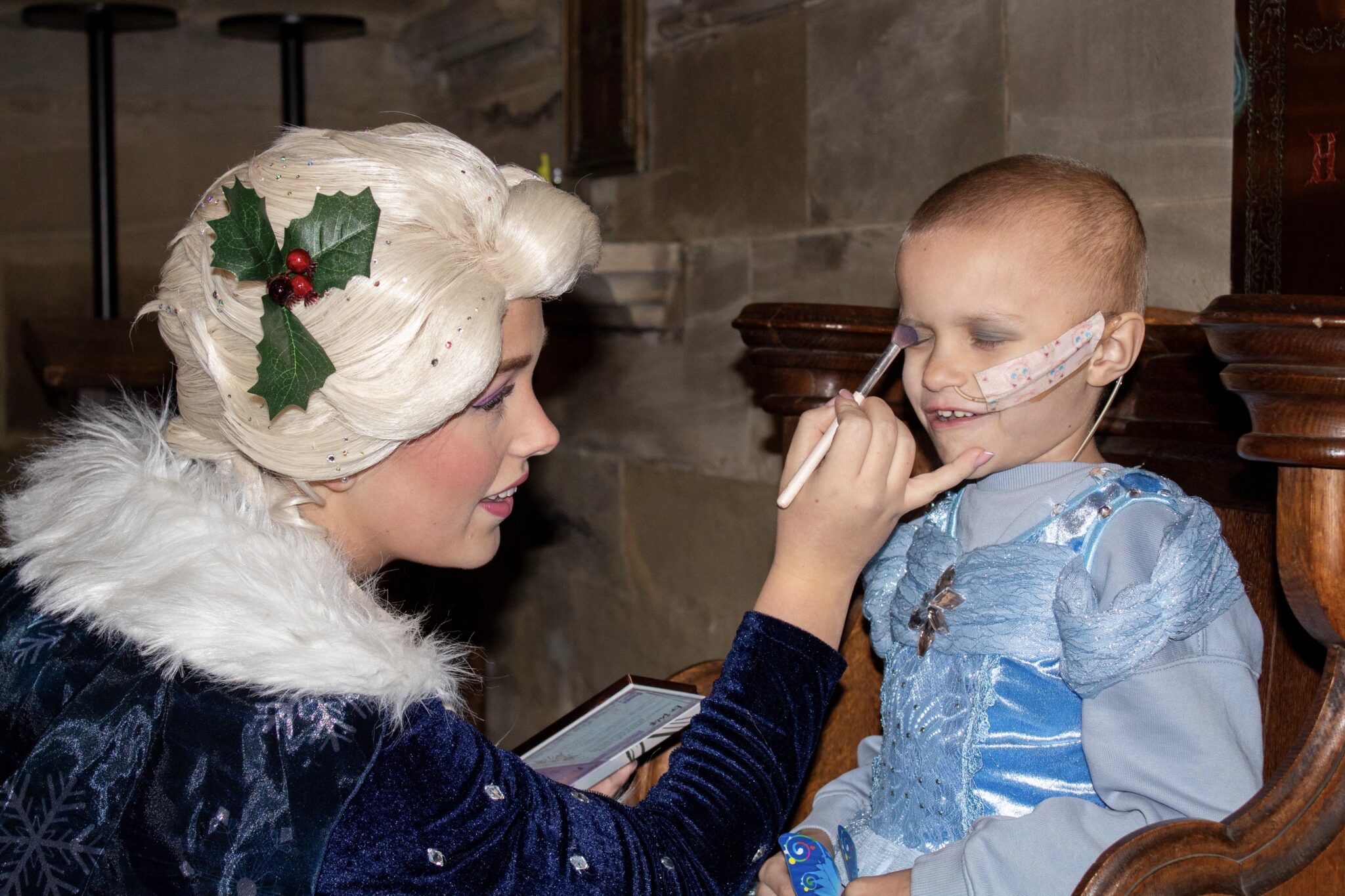 person applying make up to child