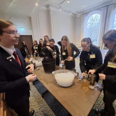 students at hotel round a table