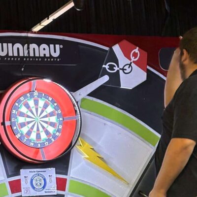 student throwing dart at dartboard