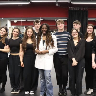 sandra godley surrounded by acting students