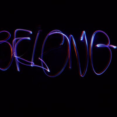 The word 'belong' made in light streaks
